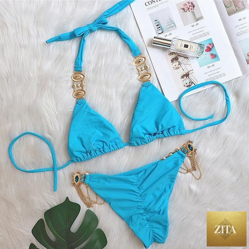 Luxury purple Stevvex bikini set featuring a halter top with crystal diamonds, low waist, and tie-side bottoms for women.