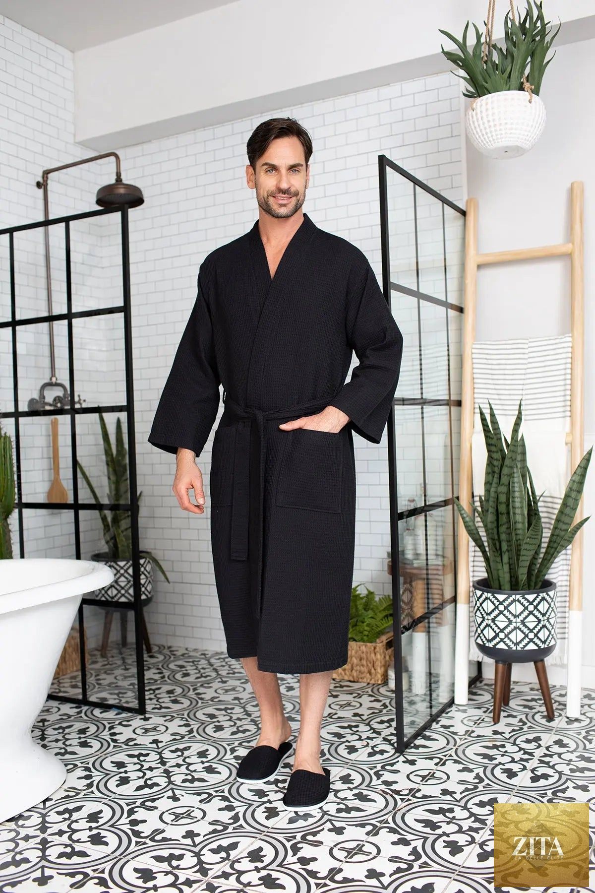 Luxury men's waffle spa bathrobe by Lotus Linen, lightweight and absorbent, shown hanging on a hook in a modern bathroom.