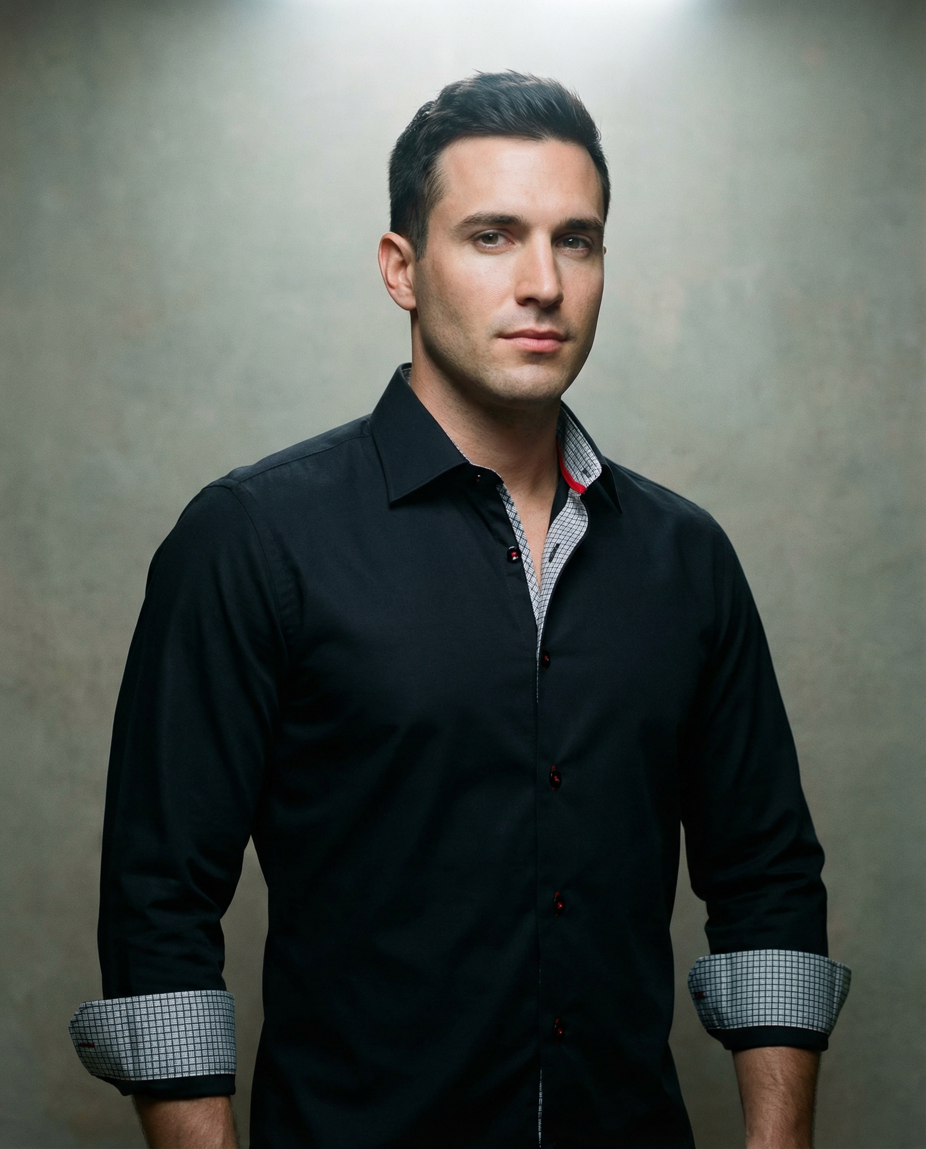Man wearing a black LEVINAS® cotton knit-stretch button-up shirt with contrast details, tailored fit, and long sleeves.