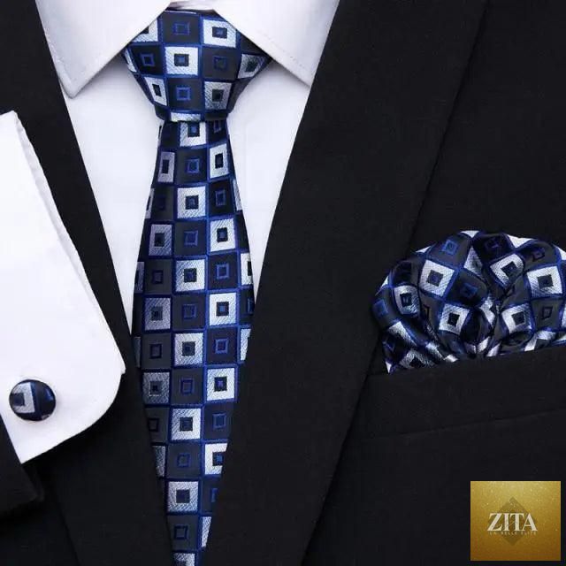 Elegant red silk men's tie with matching cufflinks and handkerchief, perfect for business or wedding suits.