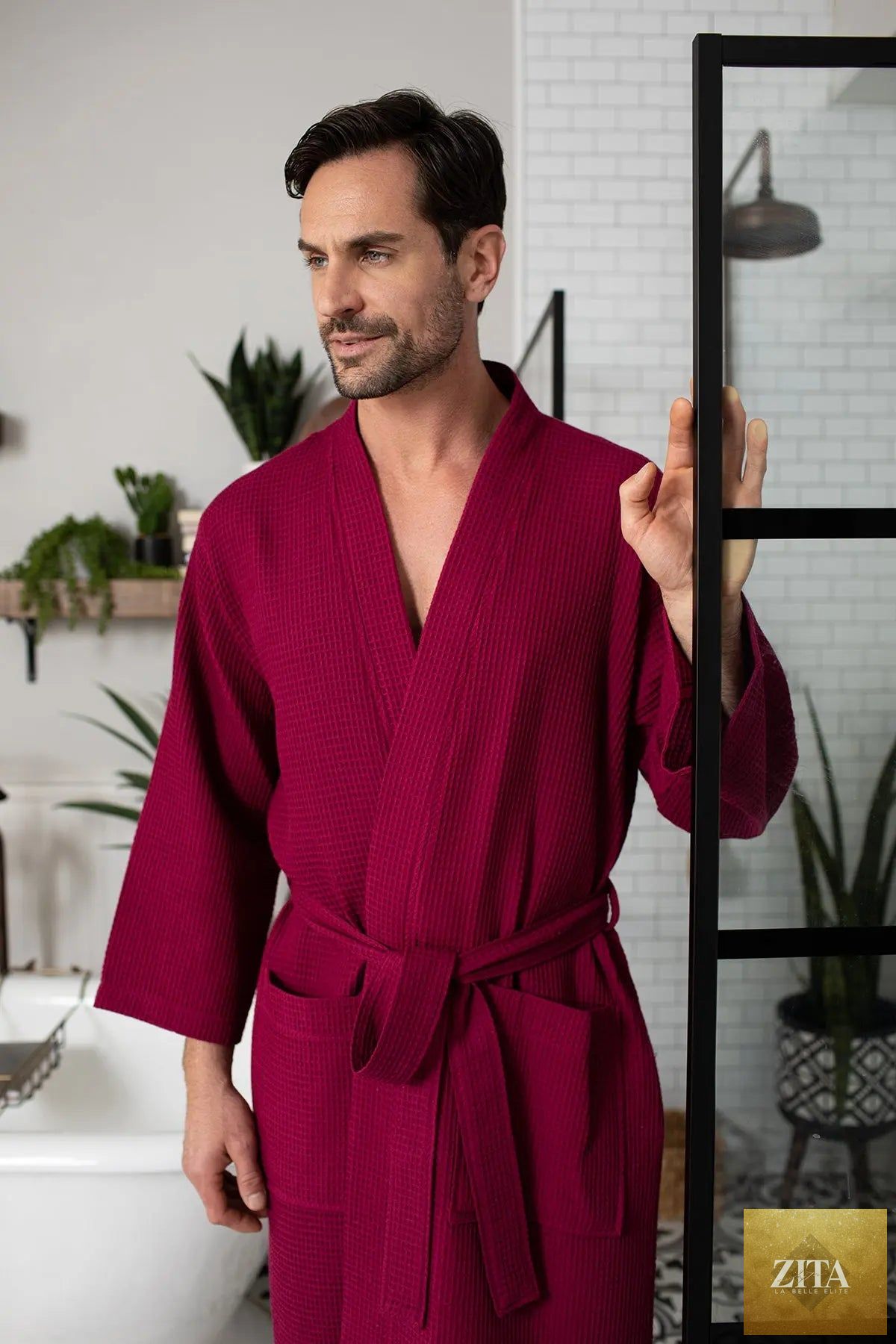 Red men's waffle spa bathrobe by Lotus Linen, lightweight and absorbent, shown hanging open with a relaxed fit.