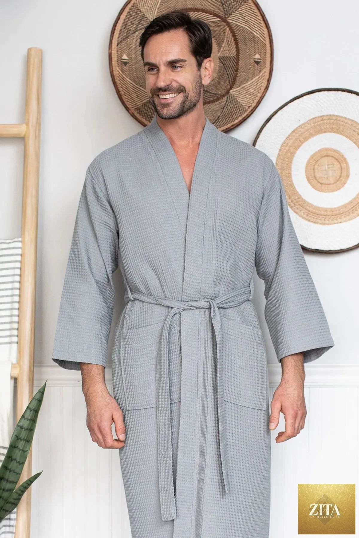 Men's waffle spa bathrobe by Lotus Linen, lightweight and absorbent, shown hanging on a wooden hook.