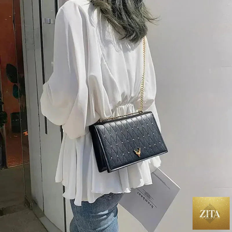 Elegant Stevvex genuine leather crossbody bag with designer chain strap, featuring a sleek modern design for women and girls.