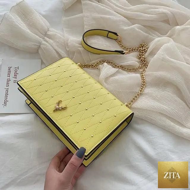 Elegant Sterling PU leather crossbody bag for women with designer chain strap, featuring a sleek modern design and spacious interior.