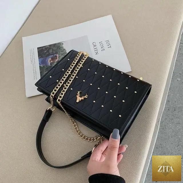 Elegant black genuine leather crossbody bag with designer chain strap from Stevvex, suitable for women and girls.