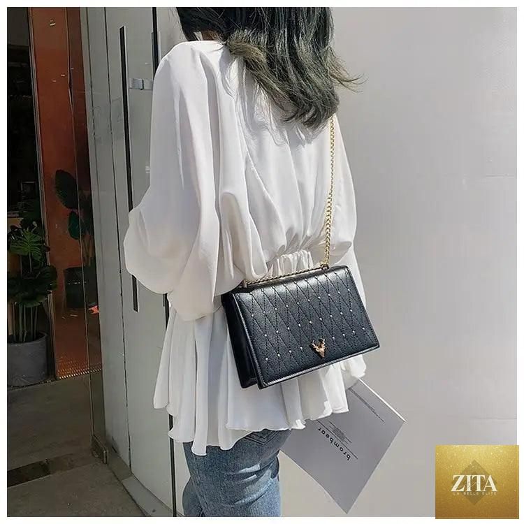Elegant Stevvex genuine leather crossbody bag for women with sleek design, chain strap, and spacious interior.