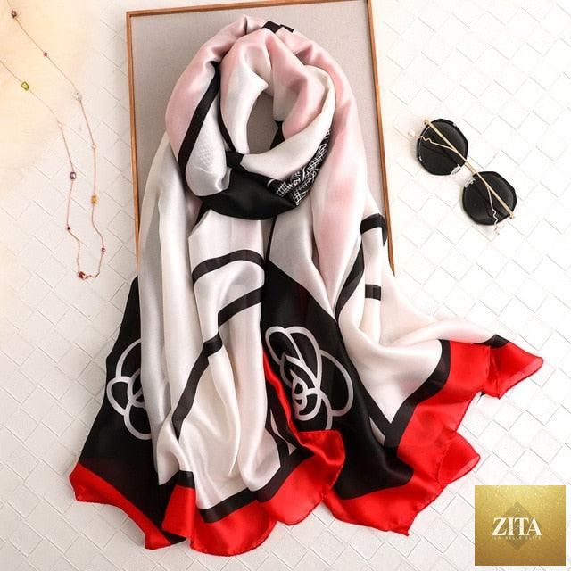 Stevvex luxury long silk winter scarf with floral print, worn as a head wrap or neck scarf, styled for women.