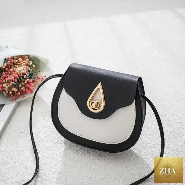 Elegant genuine leather handbag by Stevvex featuring a stylish shoulder strap, compact design, and a small shell crossbody style.