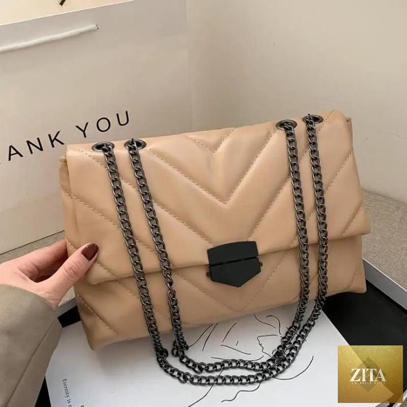 Elegant Stevvex genuine leather crossbody handbag for women, featuring a simple design with a chain strap and spacious interior.
