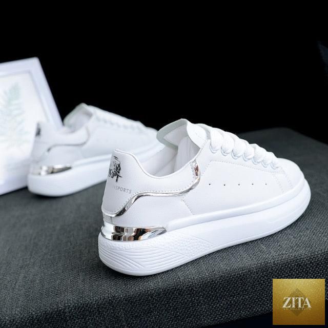 Stevvex women's white thick-soled sports sneakers with breathable material, lace-up design, perfect for running and casual wear.