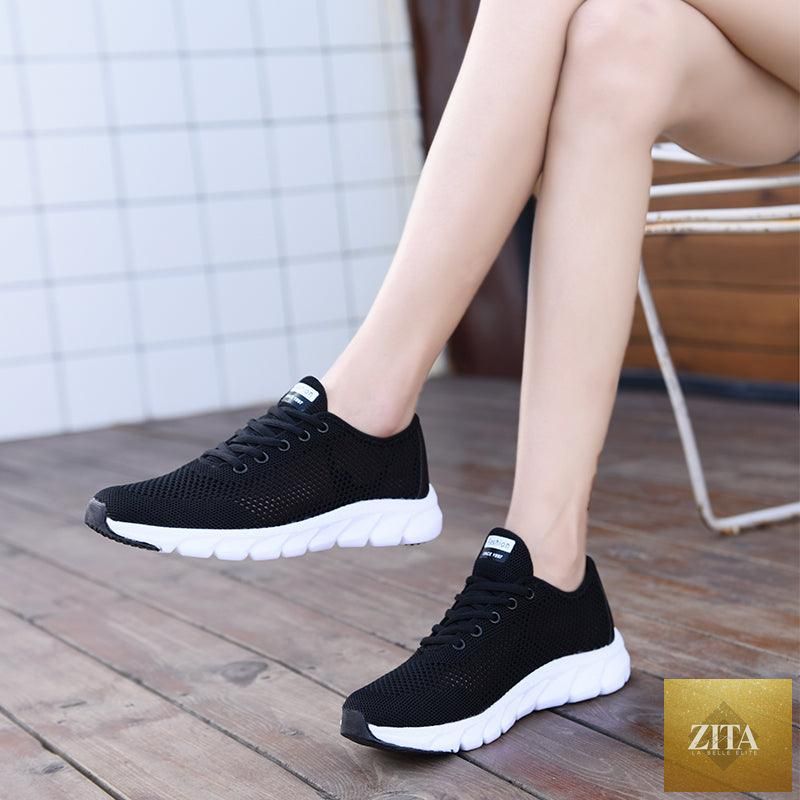 Pair of Stevvex women's breathable mesh sneakers with flat design, lightweight, non-slip soles, suitable for walking and running.