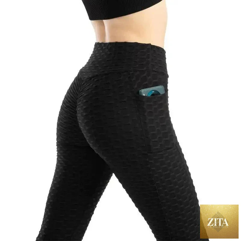Stevvex women's high waist fitness leggings with pockets, designed for workout, running, and gym activities, in sleek black fabric.