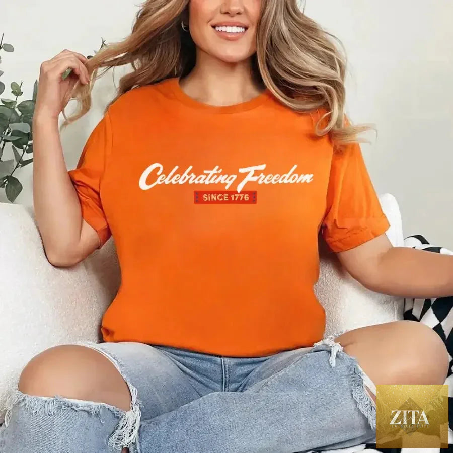 Orange 4th of July T-Shirt by Adorb Custom Tees with patriotic "Celebrating Freedom Since 1776" design.