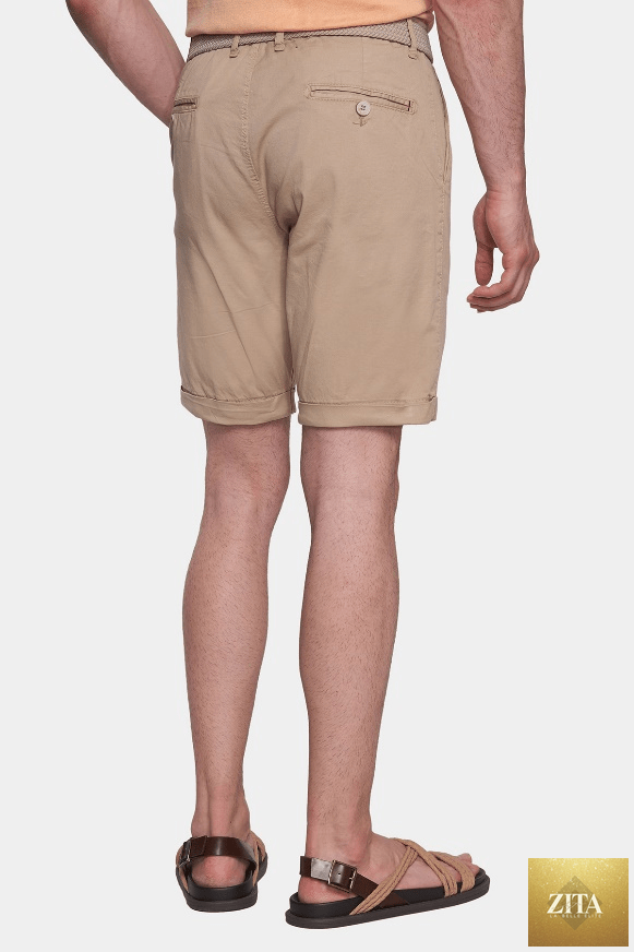 Cream summer shorts by Bright Moons, lightweight and casual for warm weather, shown on a model in a relaxed outdoor setting.