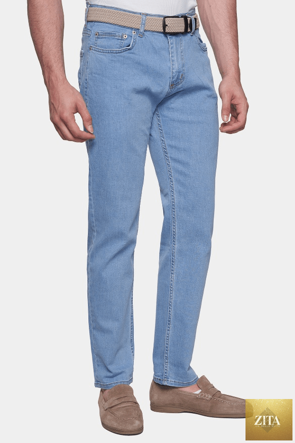 Lightwash classic jeans by Bright Moons with a relaxed fit and traditional five-pocket design, shown hanging on a wooden hanger.