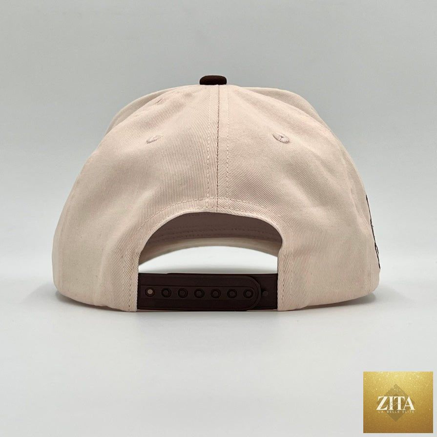 Cream and brown Malta Apparel YHWH structured snapback hat with a curved brim and adjustable strap.