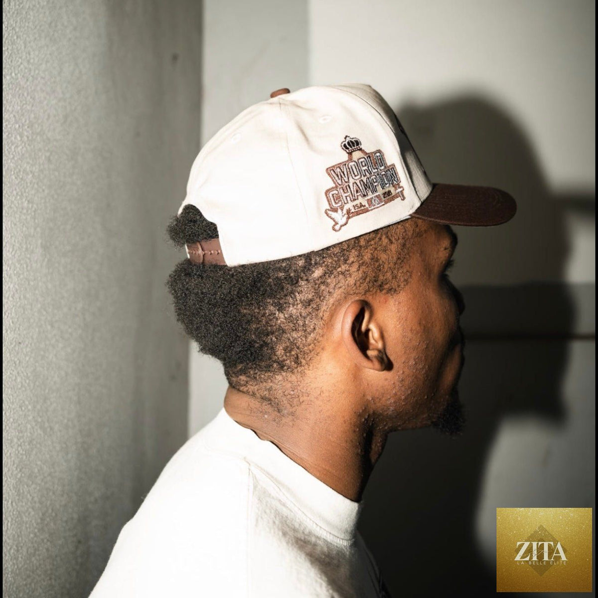Cream and brown Malta Apparel YHWH structured snapback hat with a curved brim and adjustable strap, front logo detail.