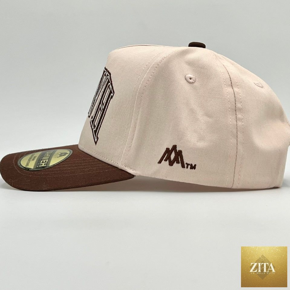 Cream and brown Malta Apparel YHWH structured snapback hat with adjustable brim and front embroidery.
