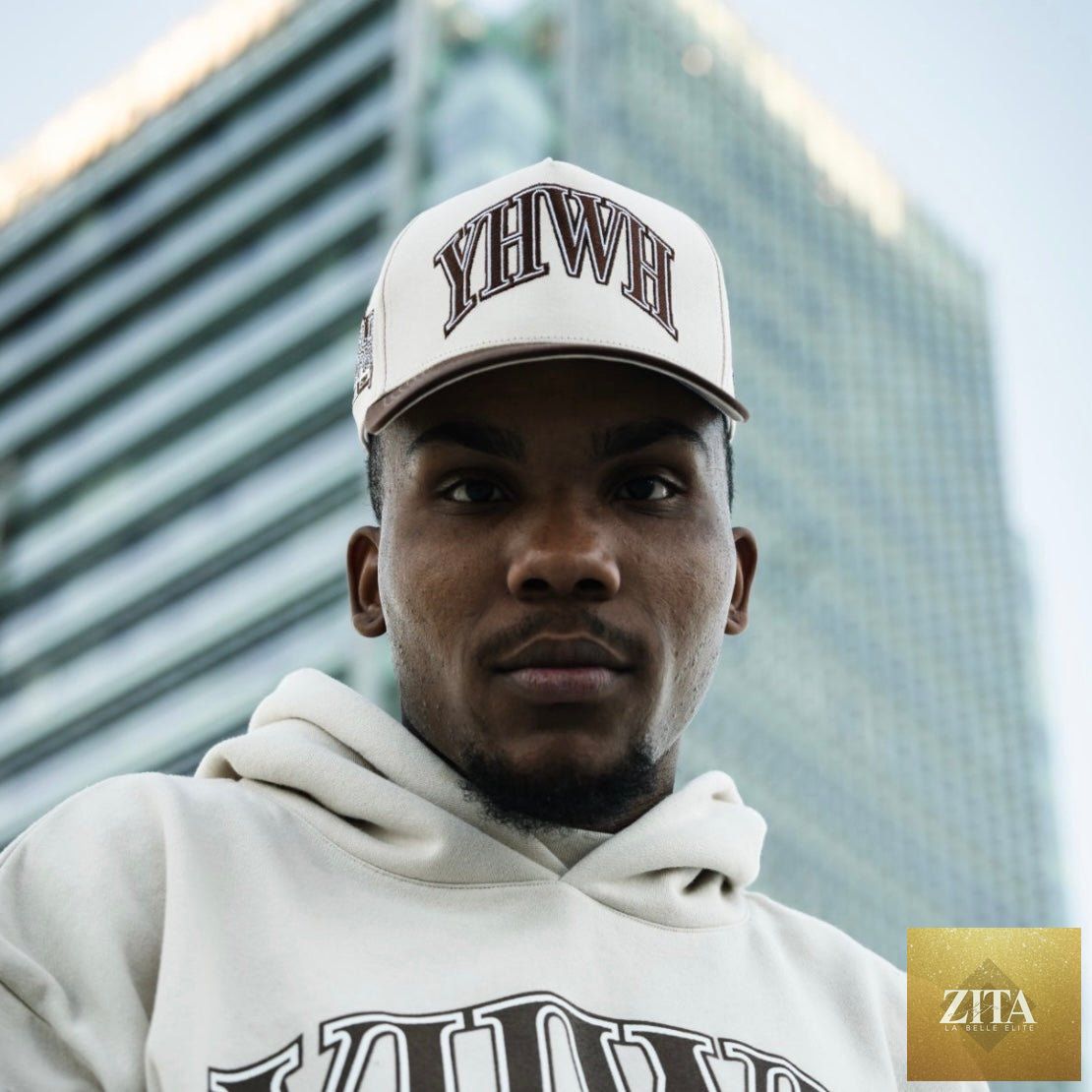 Cream and brown Malta Apparel YHWH structured snapback hat with a curved brim and adjustable strap, stylish and trendy.