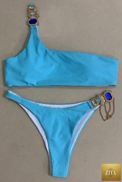 Luxury purple Stevvex bikini set featuring halter top, rhinestones, low waist, tie sides, and crystal embellishments for women.
