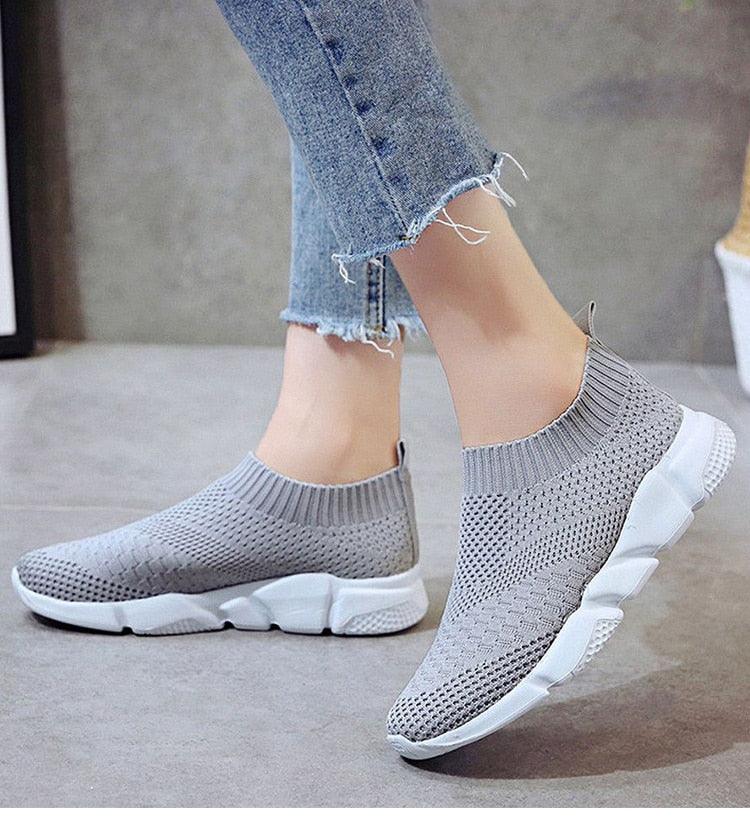 Women slip-on white sneakers by Stevvex featuring lightweight vulcanized design, breathable mesh, casual and walking shoe style.