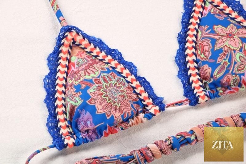 Vintage print female bikini by Stevvex with ruffle accents, high cut, halter string, triangle top, and two-piece swimwear design.