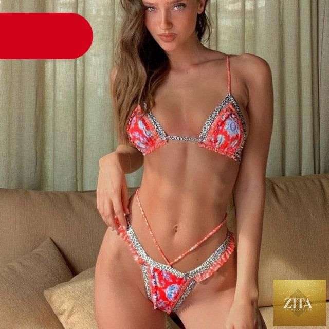 Vintage print female bikini by Stevvex featuring a high-cut, ruffle, halter, triangle design, two-piece swimwear with string details.