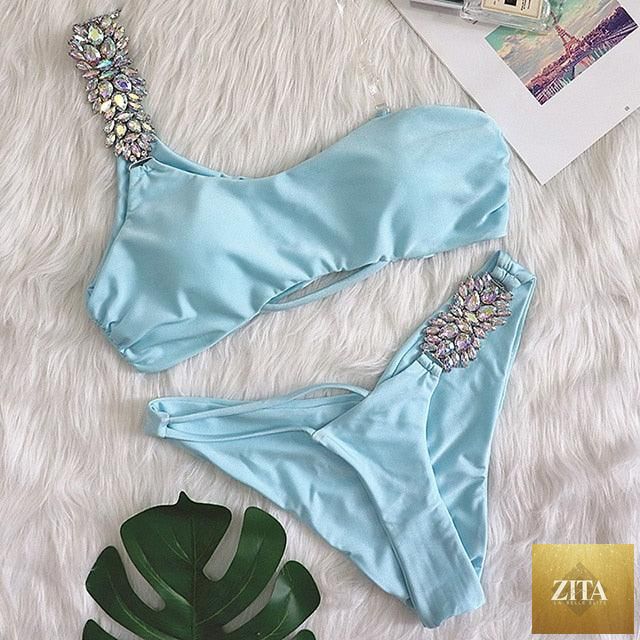 Luxury purple diamond bikini set by Stevvex featuring halter top, low waist, rhinestone embellishments, and tie side bikini for women