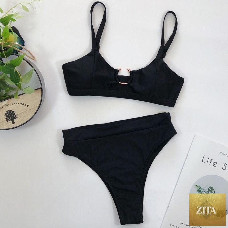 Women’s high waist bikini swimsuit by Stevvex featuring metal ring cross bandage design, cutout details, and tie back style.