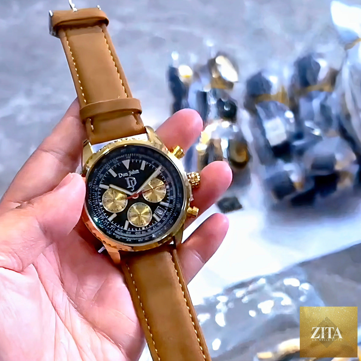 Elegant gold watch by donjohnbyvictoriacharles with a sleek round face and gold band, showcasing luxurious craftsmanship.