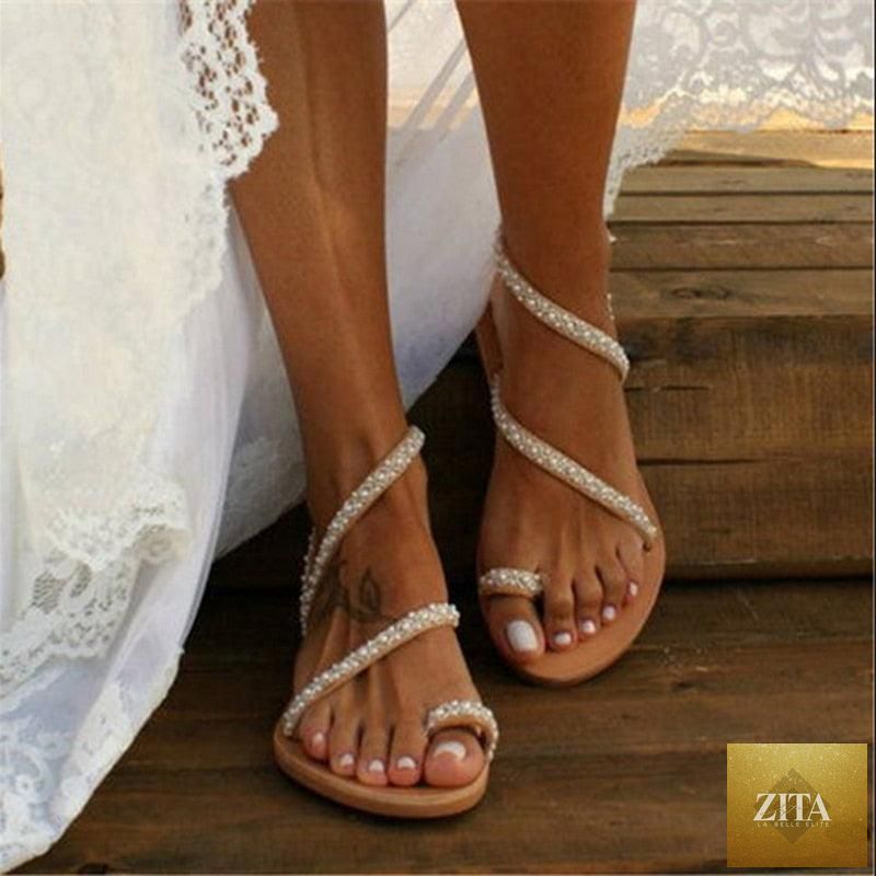 Stevvex summer flat sandals with pearl decorations, leather straps, rhinestones, open toe design, ideal for beach and holiday wear.