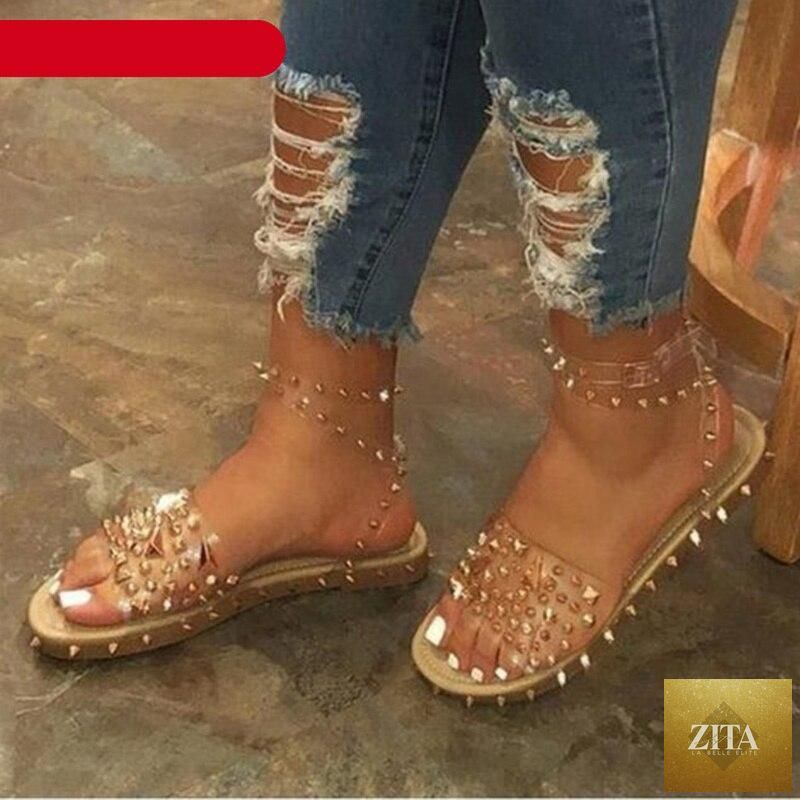 Stevvex women's flat summer sandals with transparent straps, buckle closure, open toe design, and ankle strap for casual wear.