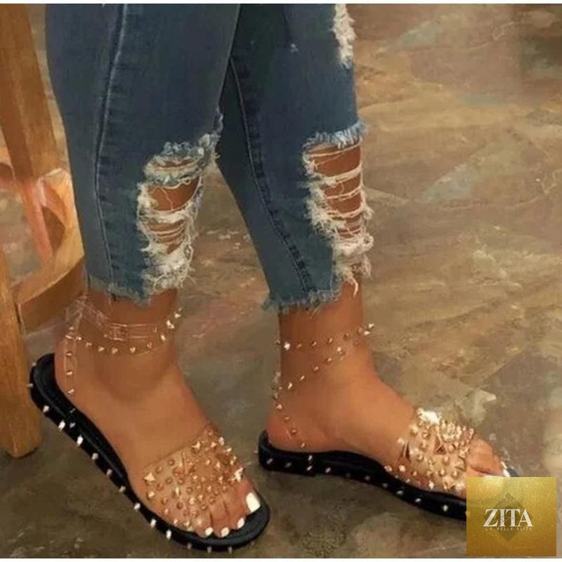 Stevvex women's summer flat sandals with transparent buckle straps, open toe, ankle strap, and adjustable buckle for casual or beach wear.