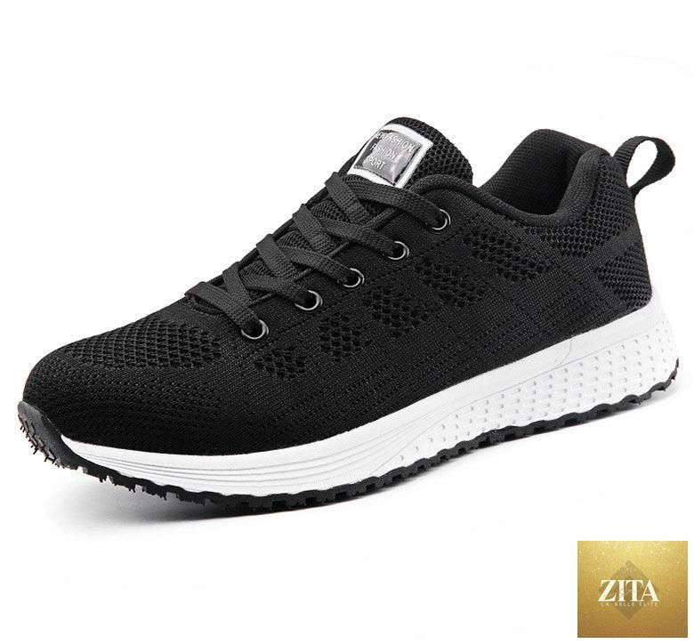 Stevvex women's white sneakers with breathable mesh, casual flats, soft comfort, non-slip soles, ideal for walking and everyday wear.