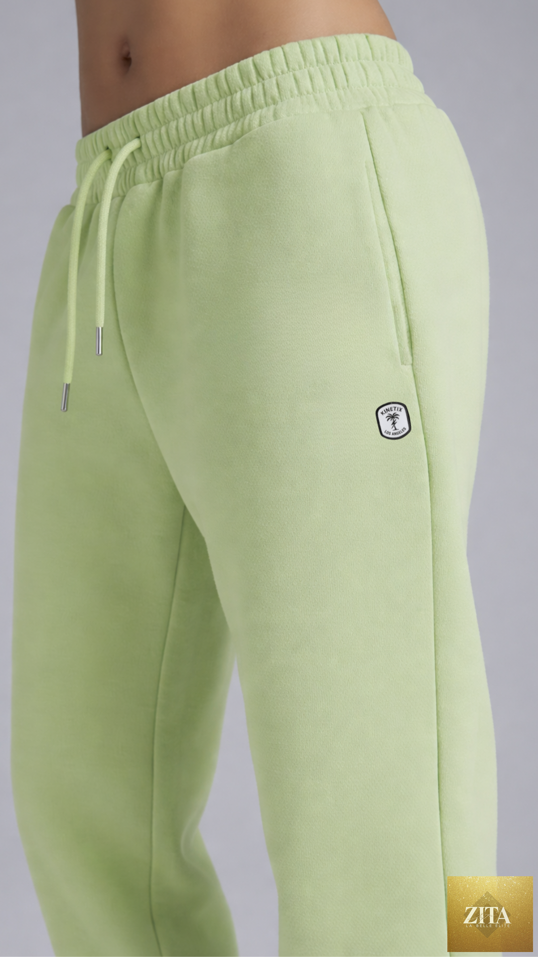 Lime green women's sweatsuit by Kinetix Casual Luxury, featuring comfortable sweatpants with an elastic waistband and relaxed fit.