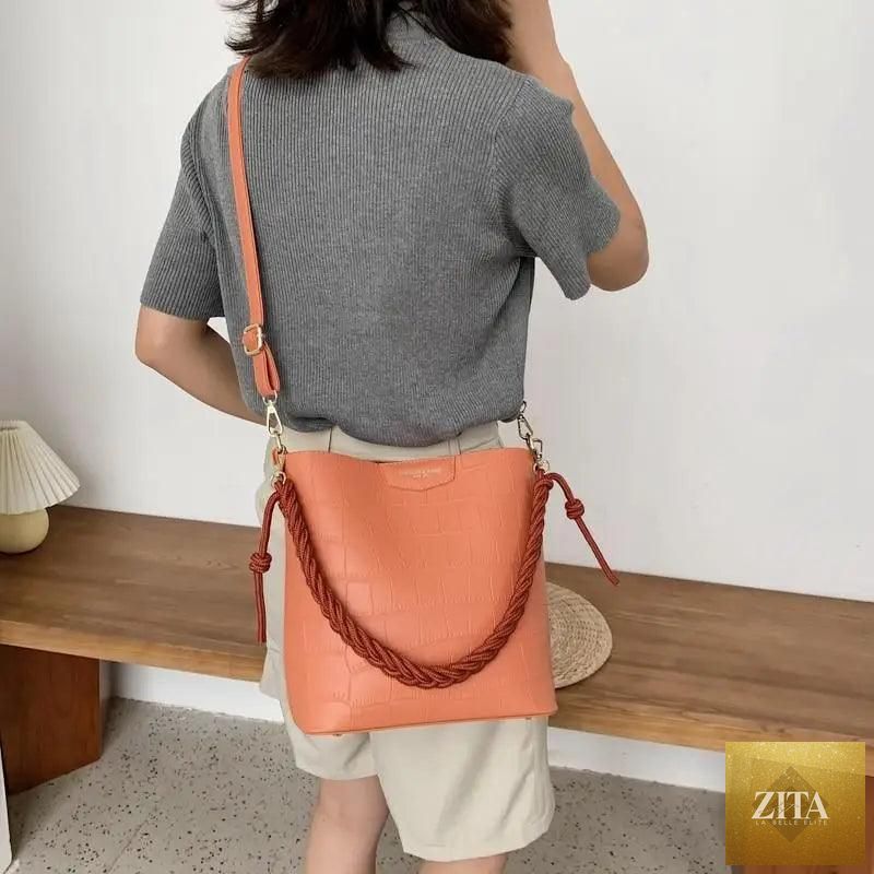 Elegant genuine leather women's bucket bag with a stone pattern, featuring a vintage style shoulder design by Stevvex.