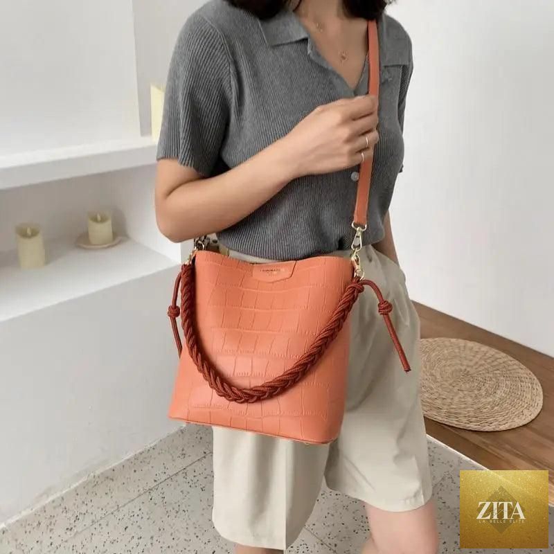 Elegant genuine leather women's bucket shoulder bag by Stevvex with vintage stone pattern and stylish diagonal design.