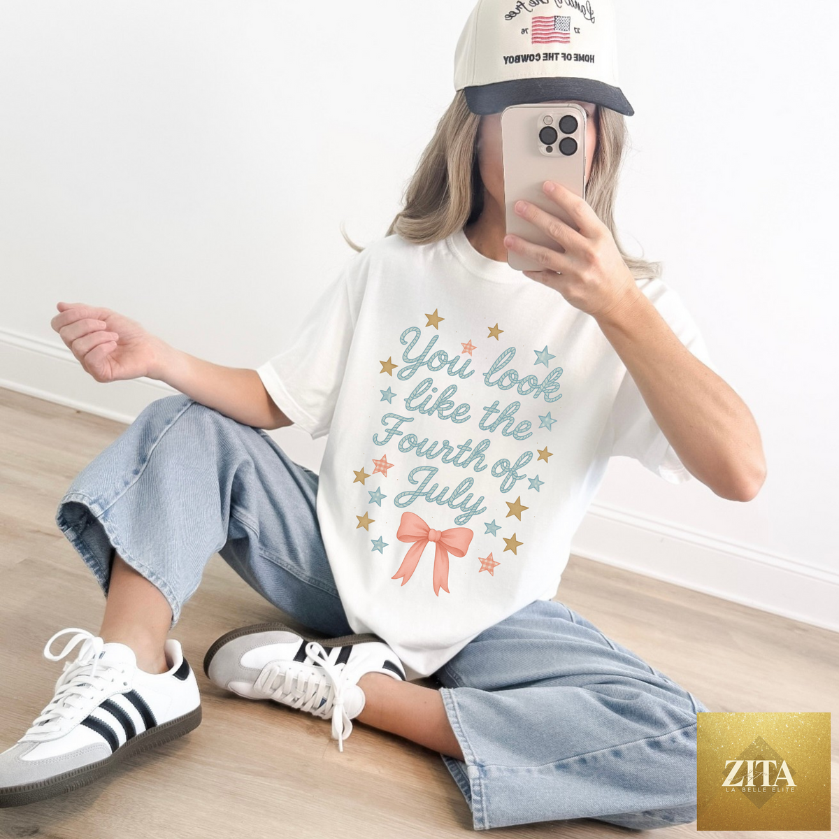 White graphic tee by Hey Jude Graphic Tees featuring a colorful Fourth of July design and patriotic text on the front.