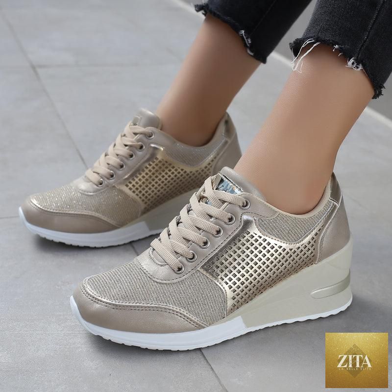 Women’s gold and silver Stevvex walking and jogging sneakers, lightweight, casual, with height-increasing design and comfortable fit.
