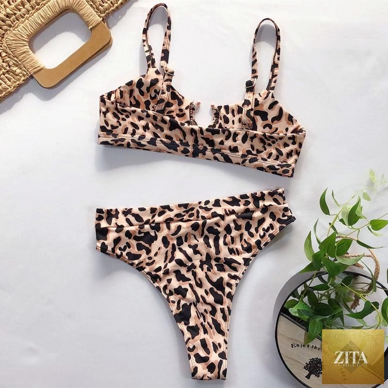 Women’s high-waist bikini swimsuit with metal ring cross design, cutout details, tie-back, and thong style, by Stevvex.