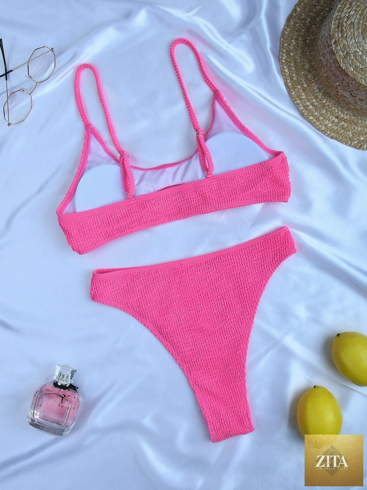 Women wearing a high-waist striped bikini with metal ring accents, cross bandage design, and tie-back closure, in a two-piece swimsuit.