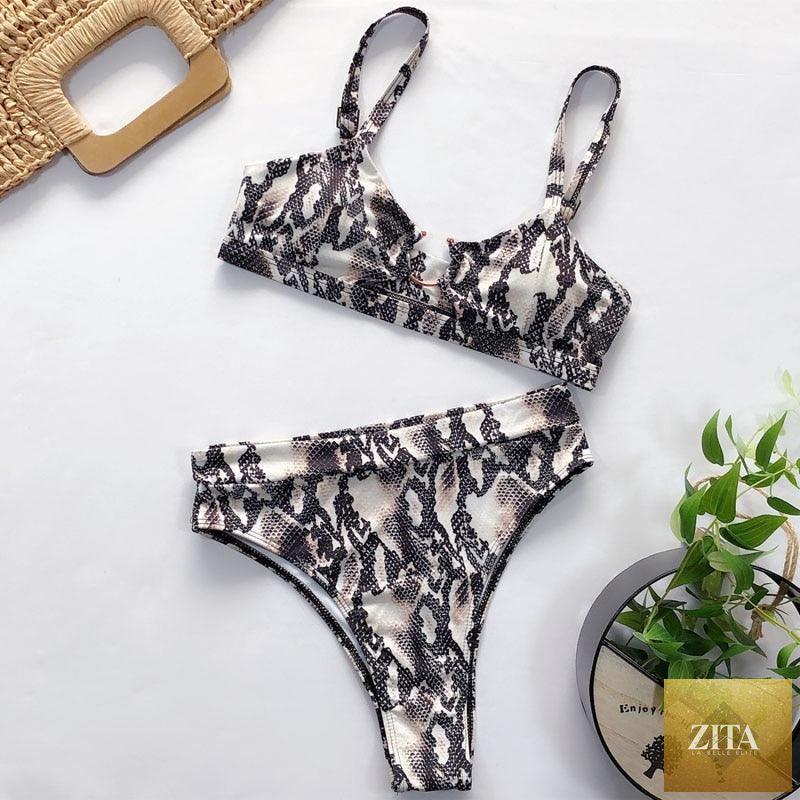 Women’s high-waist bikini swimsuit with metal ring details, cross bandage design, cutout, and tie-back style, by Stevvex.
