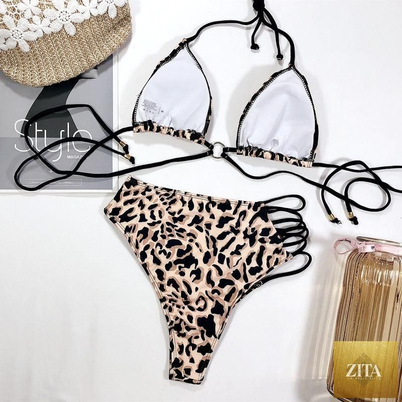 Women’s high waist bikini swimsuit with metal ring cross bands, cutout design, tie back, and thong style from Stevvex.