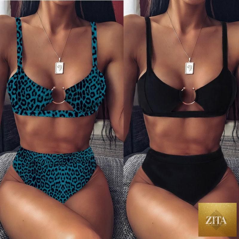 Women’s high waist bikini swimsuit with metal ring accents, cross bandage design, cutouts, and tie-back, in a two-piece thong style.