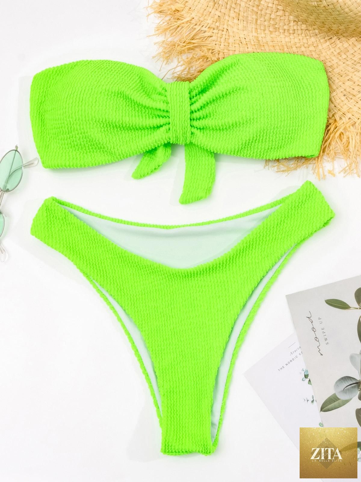 Women’s high-waist bikini swimsuit with metal ring accents, cross bandage design, cutout details, tie-back, and thong style by Stevvex.