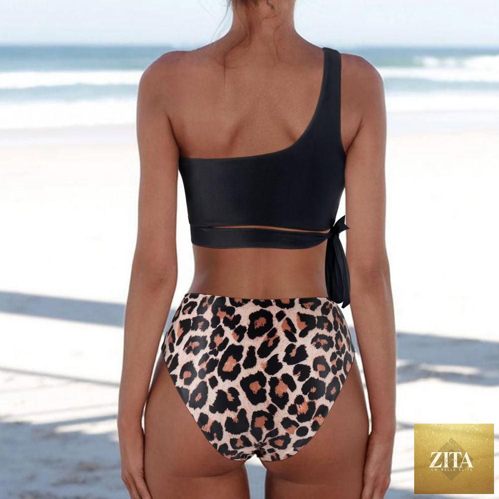 Women wearing Stevvex leopard print bikini with one-shoulder top and high-waist bottoms, suitable for summer beachwear.