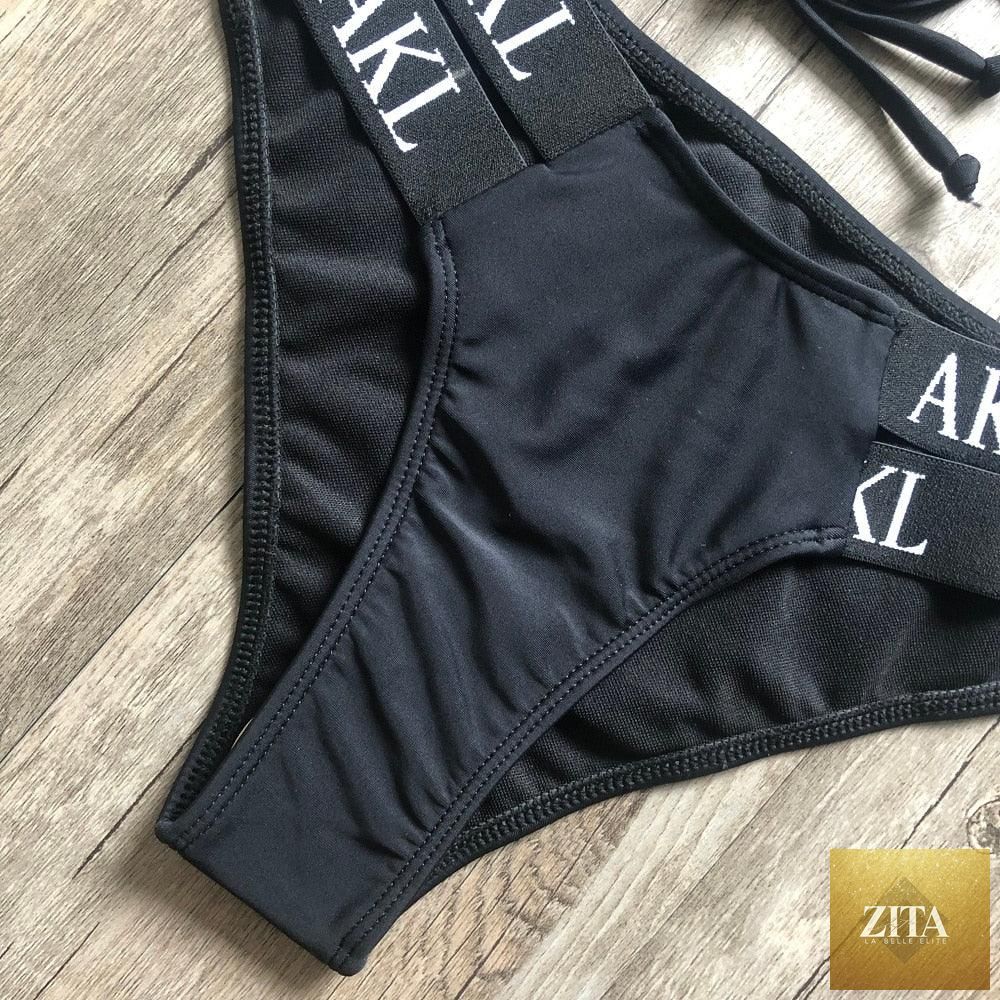 Women’s luxury black and white swimwear by Stevvex, push-up bikini with lace-up design, halter style, letter print, and bandage fit.
