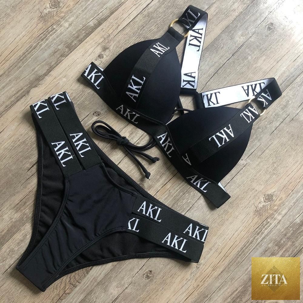 Women’s luxury black and white swimwear by Stevvex featuring a push-up bikini, lace-up design, halter style, and letter print.