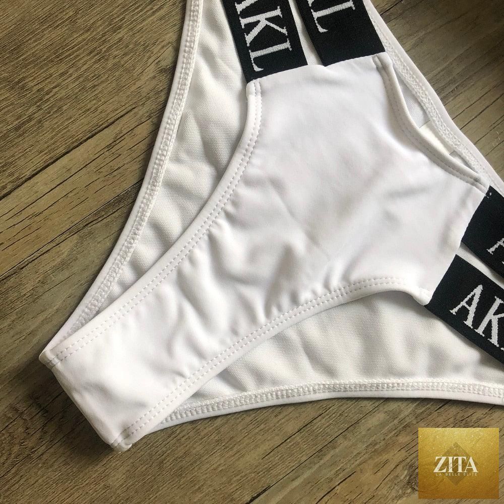 Women Stevvex luxury black and white push-up bikini with lace-up design, halter bandage style, letter printing, and mini summer swimsuit.