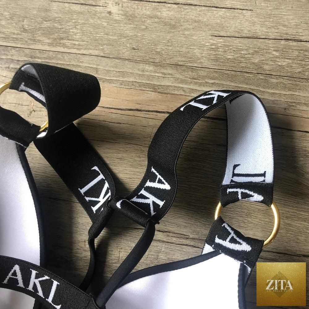 Women’s luxury black and white swimwear by Stevvex, push-up bikini with lace-up design, halter bandage style, and letter print.